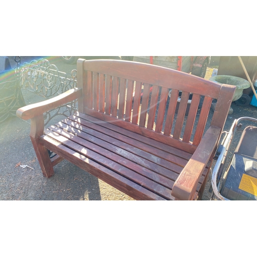 414 - Vintage wooden park bench with slatted back and seat, featuring sturdy armrests and made of a durabl... 