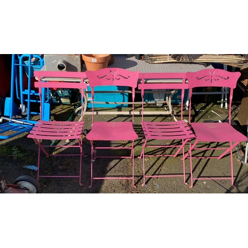 421 - Set of four pink metal folding garden chairs with decorative cut-out backs.