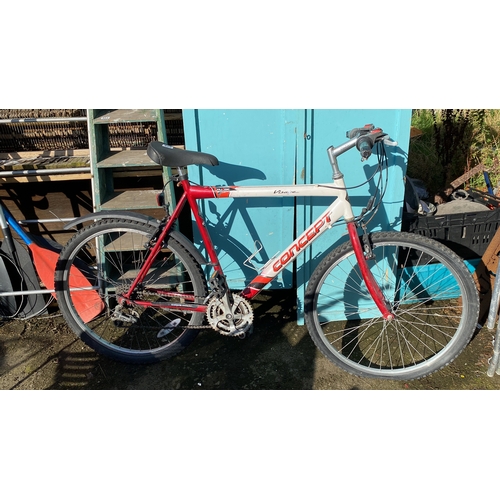 425 - Mountain bike with Shimano gear system, red and white frame, and ProMax handbrakes.