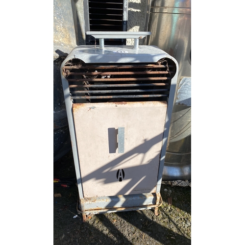 431 - Vintage metal heater with a cylindrical chimney and front grill design.