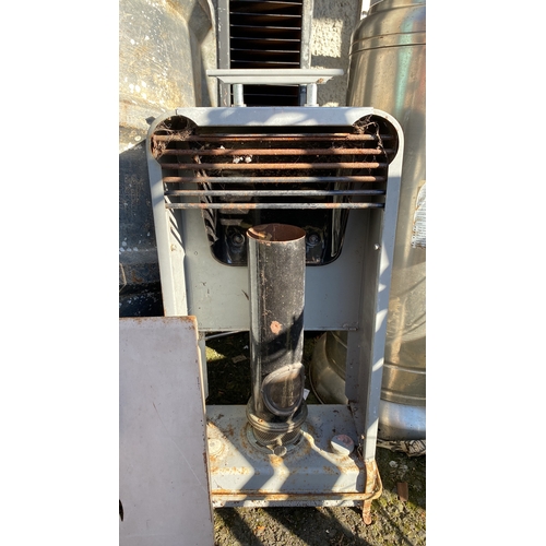 431 - Vintage metal heater with a cylindrical chimney and front grill design.