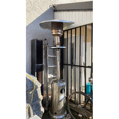 432 - Stainless steel patio heater with a rounded base and reflector.