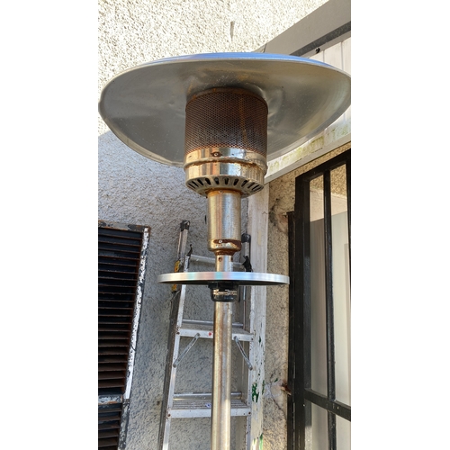 432 - Stainless steel patio heater with a rounded base and reflector.