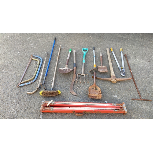 435 - Mixed lot of assorted garden tools including saws, pickaxe, shovels, fork, trowel, shears, and broom... 