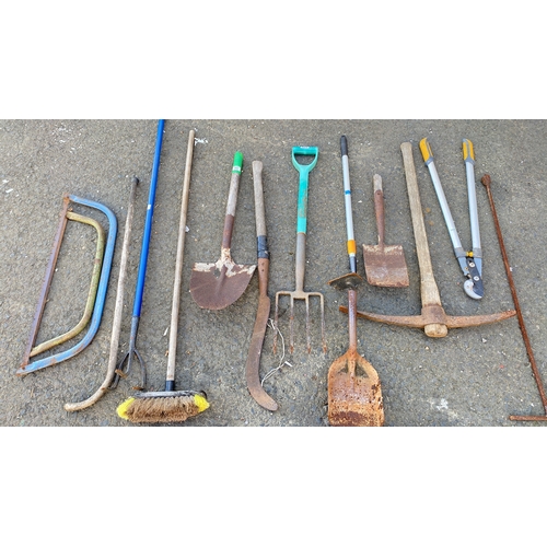 435 - Mixed lot of assorted garden tools including saws, pickaxe, shovels, fork, trowel, shears, and broom... 