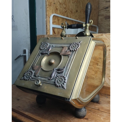 371 - Antique brass and copper coal scuttle with floral and leaf design, featuring a black wooden handle a... 