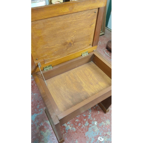 373 - Mid-Century Modern walnut vanity stool with hinged storage compartment, light pink fabric cushion to... 