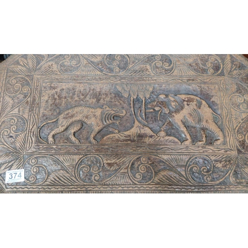 374 - Carved wooden table featuring animal motifs and detailed scrollwork, made from dark wood, from the e... 