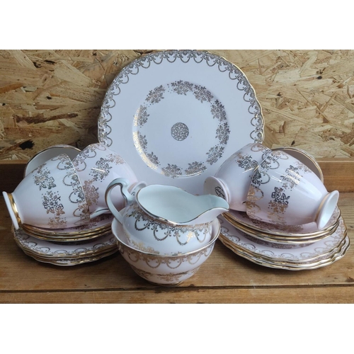 375 - 15-piece Royal Stafford bone china tea set features gold floral and scroll patterns on a white backg... 