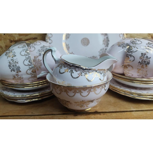 375 - 15-piece Royal Stafford bone china tea set features gold floral and scroll patterns on a white backg... 