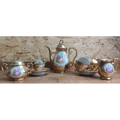 386 - Porcelain tea set with gold accents featuring romantic Fragonard scenes includes teapot, creamer, su... 