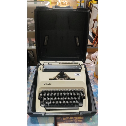 388 - Adler Gabriele 25 vintage typewriter in hard case. Bone and black color scheme with German QWERTY ke... 