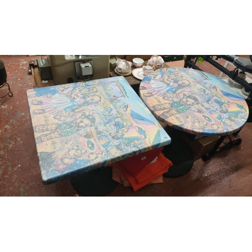 390 - Pair of whimsical tables feature vibrant teddy bear carnival scene designs. One is round and the oth... 