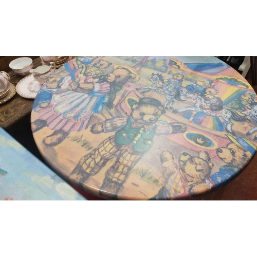 390 - Pair of whimsical tables feature vibrant teddy bear carnival scene designs. One is round and the oth... 