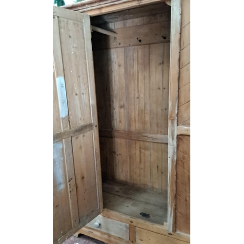 320 - Antique wooden wardrobe featuring chevron pattern doors and two drawers, made from pine. Early 20th-... 