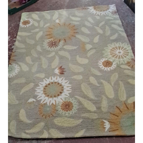 325 - Handwoven carpet features a floral motif with green, beige, and rust colors. Detailed flower and lea... 