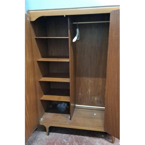 327 - Mid-Century Modern teak wardrobe with double doors, shelving, and hanging space.