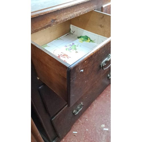 328 - Antique wooden chest of drawers with four spacious drawers and ornate metal handles, featuring a lin... 