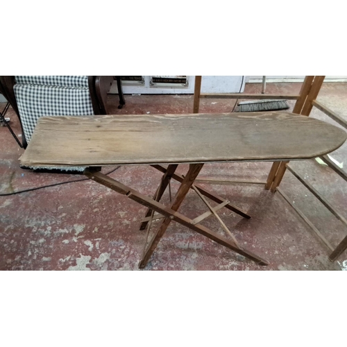 331 - Vintage wooden ironing board with collapsible legs. Features a rustic, natural wood finish.