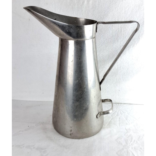 336 - Vintage stainless steel pitcher, from the mid-20th century. It features a curved spout and angular h... 