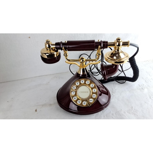 339 - MyBelle Cherie Model 383 dark cherry rotary dial telephone features gold-tone accents and vintage-in... 