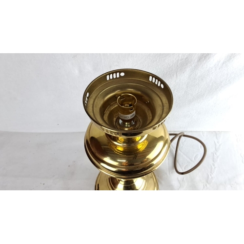 340 - Vintage electric brass table lamp features a classic urn shape design with a polished finish and flu... 