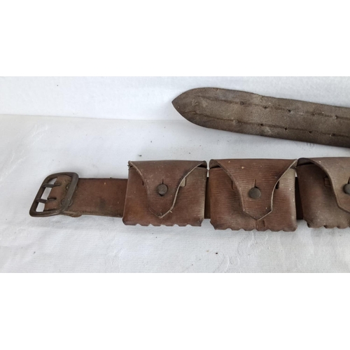 343 - Antique leather ammunition belt with multiple pouches and metal buckle, featuring aged patina, from ... 