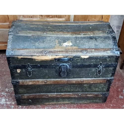 349 - Antique wooden steamer trunk with metal straps and leather handles. Interior lined with striped fabr... 