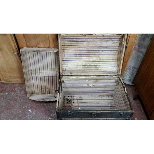 349 - Antique wooden steamer trunk with metal straps and leather handles. Interior lined with striped fabr... 