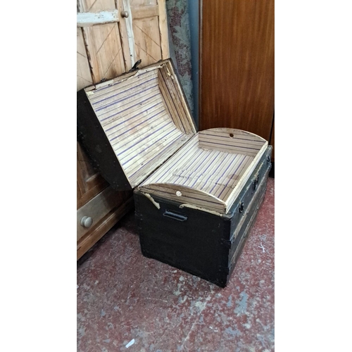 349 - Antique wooden steamer trunk with metal straps and leather handles. Interior lined with striped fabr... 