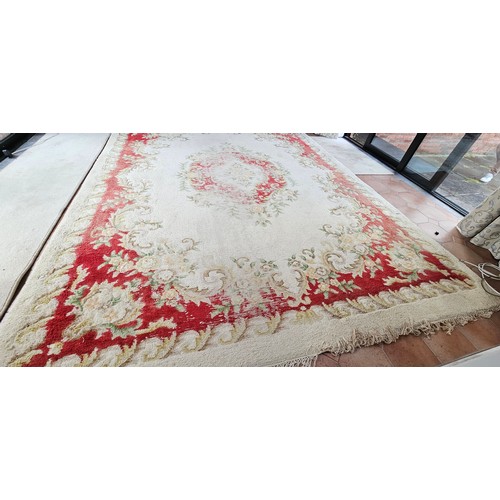 326 - large vintage floral-patterned wool rug, featuring muted reds and greens.