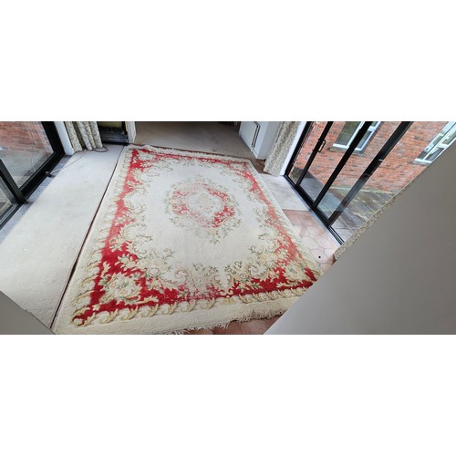 326 - large vintage floral-patterned wool rug, featuring muted reds and greens.