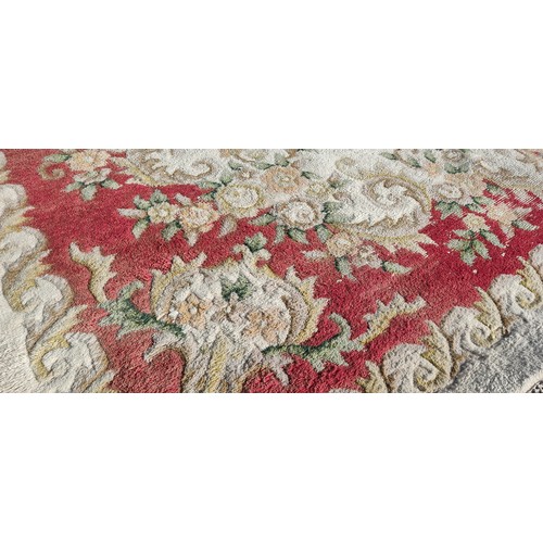 326 - large vintage floral-patterned wool rug, featuring muted reds and greens.