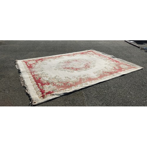 326 - large vintage floral-patterned wool rug, featuring muted reds and greens.