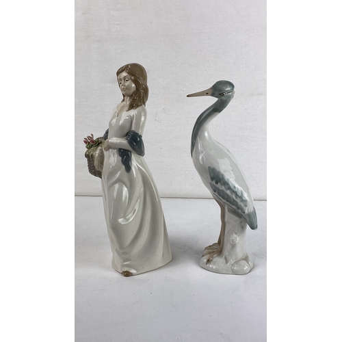 16 - Pair of porcelain figurines, depicting a woman and a heron. Marked by Mirmasu, Spain.