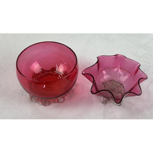 17 - Pair of cranberry glass bowls with crimped bases.