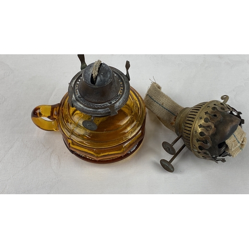 2 - Amber glass oil lamp with metal fittings, featuring a wick and separate dome top.