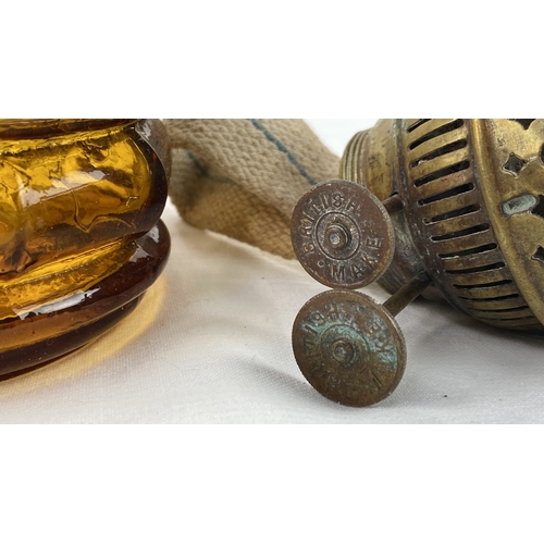 2 - Amber glass oil lamp with metal fittings, featuring a wick and separate dome top.