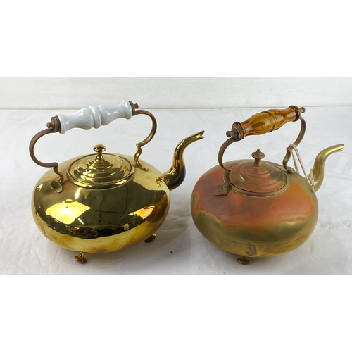 20 - Pair of vintage brass kettles with ornate, decorative handles.