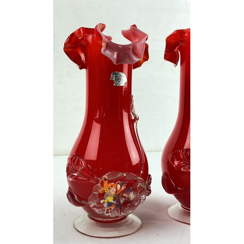 24 - Pair of ruffled red glass vases with applied floral decoration.