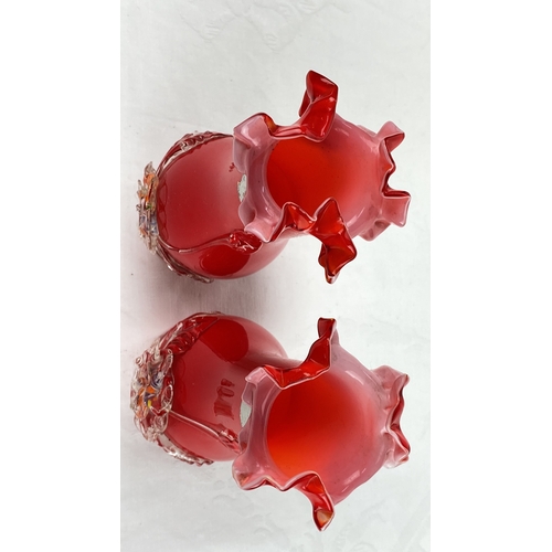 24 - Pair of ruffled red glass vases with applied floral decoration.