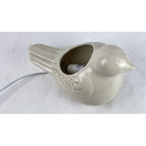 41 - Ceramic bird-shaped lamp, off-white, with cut-out details.