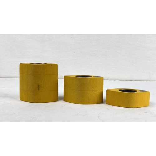 56 - Set of three  yellow wooden candle holders with stainless steel inserts. Danish design by Woodcraft.