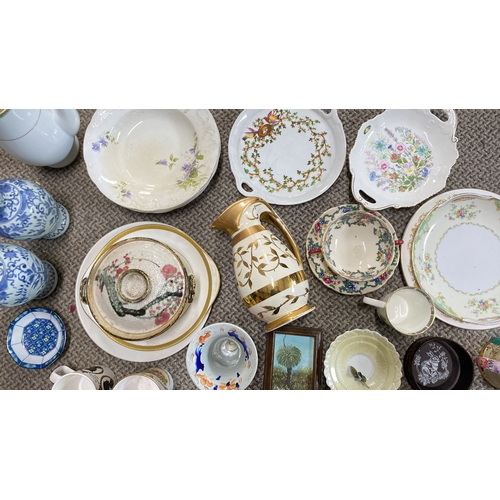 426 - Assorted vintage porcelain tablewares with floral and gilt designs, including plates, cups, jug, and... 