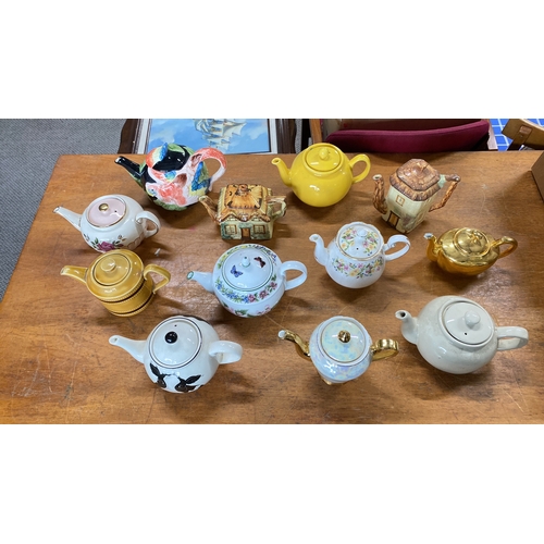 429 - Collection of teapots featuring various designs and themes, including floral and animal motifs.