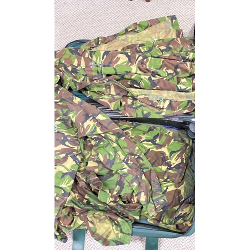 431 - Collection of military clothing, featuring camouflage jackets, shirts, and netting. Includes various... 