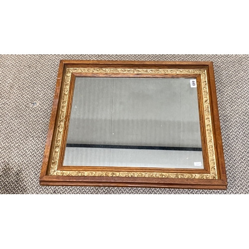 449 - Rectangular mirror with an ornate oak frame and a detailed floral inner border.  Measuring 69x59cm.