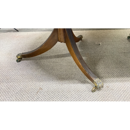 456 - Mahogany extending dining table with twin pedestal base and brass claw feet. Approximately 72 inches... 