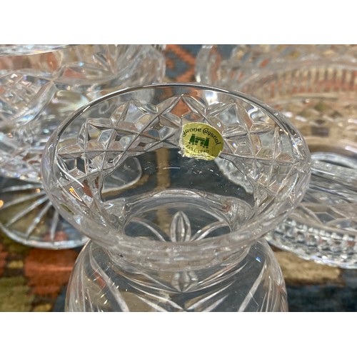 54 - Set of four cut glass crystal pieces, including a scalloped bowl with engraved detail.