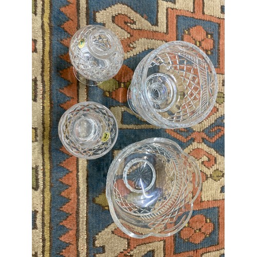 54 - Set of four cut glass crystal pieces, including a scalloped bowl with engraved detail.